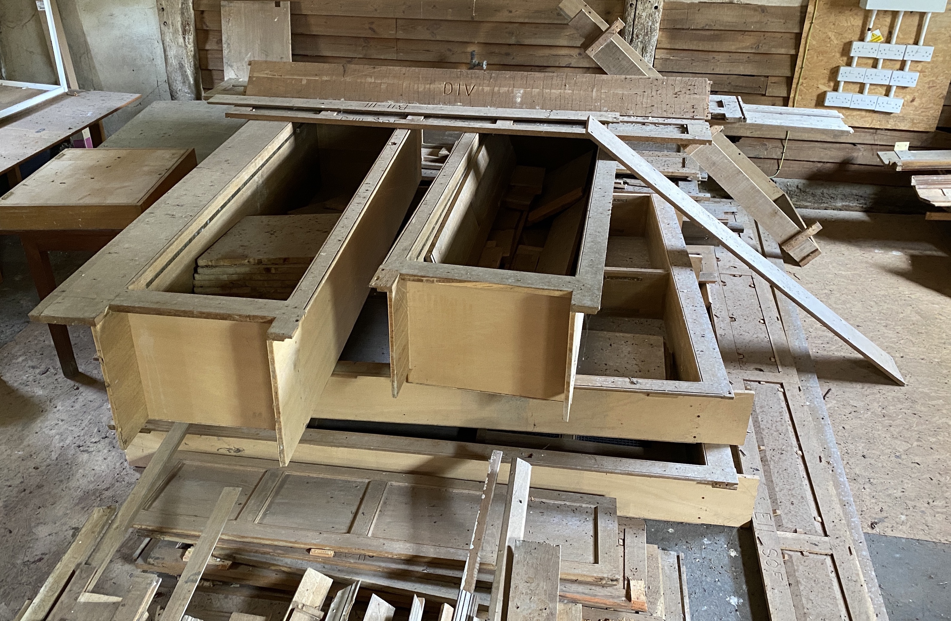 Three dismantled oak bookcases, formerly in the library at Plumpton Place, consisting of an ‘’L’’ shaped section, 455cm, the return 124cm; another ‘’L’’ section, 110cm, the return 68cm, and single section, 255cm, Overall